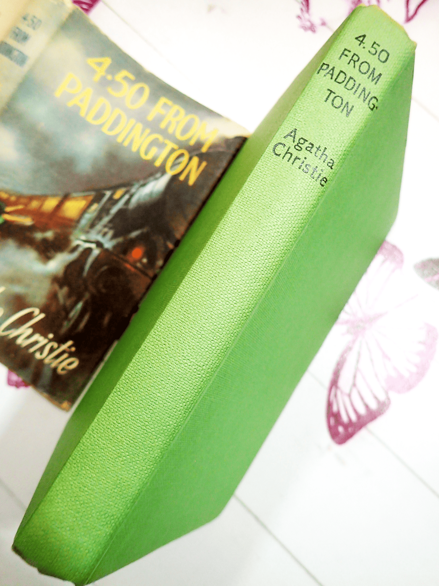 Green cloth covered boards of Agatha Christie 4.50 from Paddington Classic Vintage Crime Fiction book showing spine with black titles against the pictorial dustjacket.