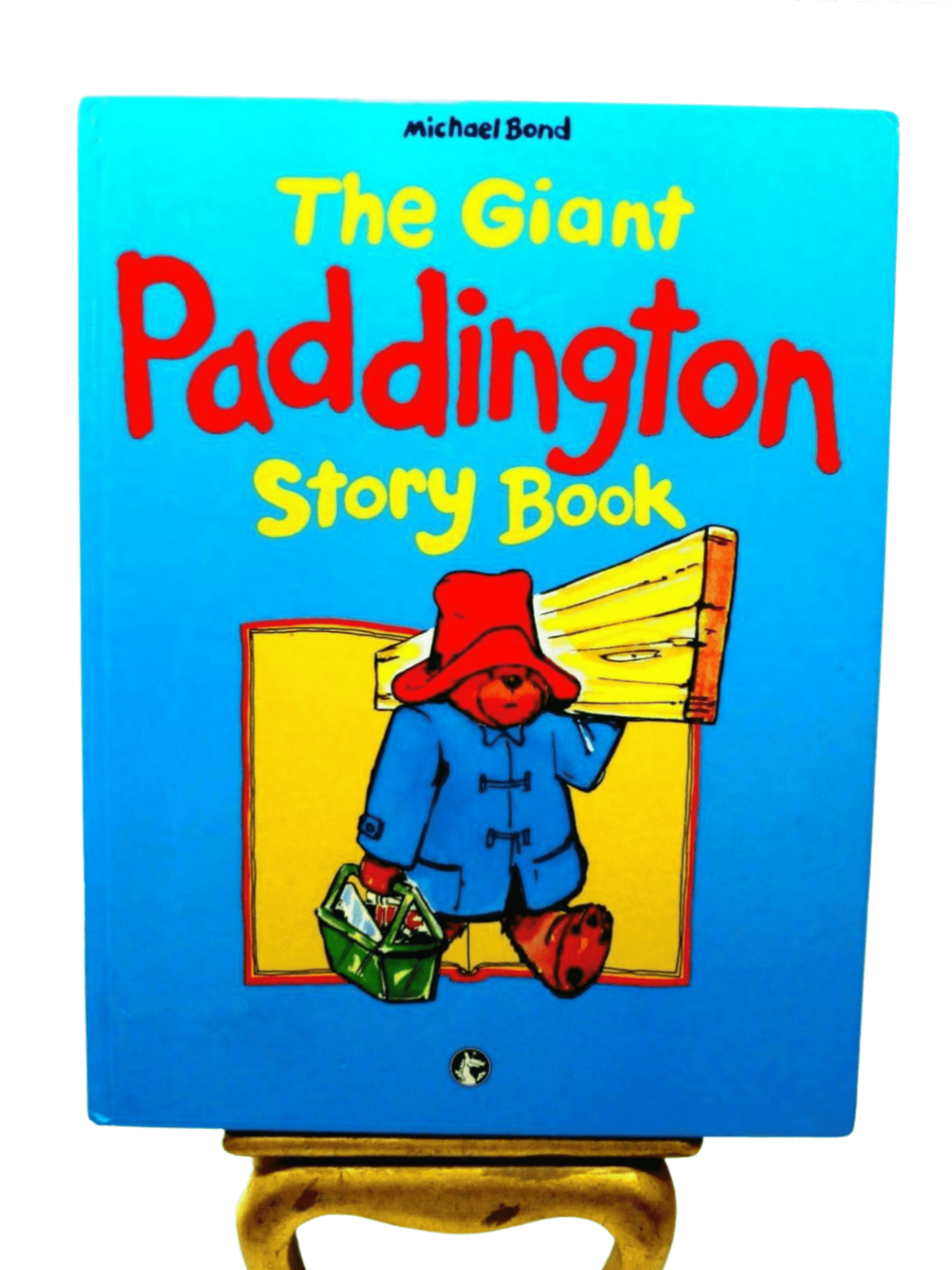 Front Cover of The Giant Paddington Story Book by Michael Bond Paddington Bear First Ed. 1989 showing Paddington Bear carrying some wood and a toolbox.