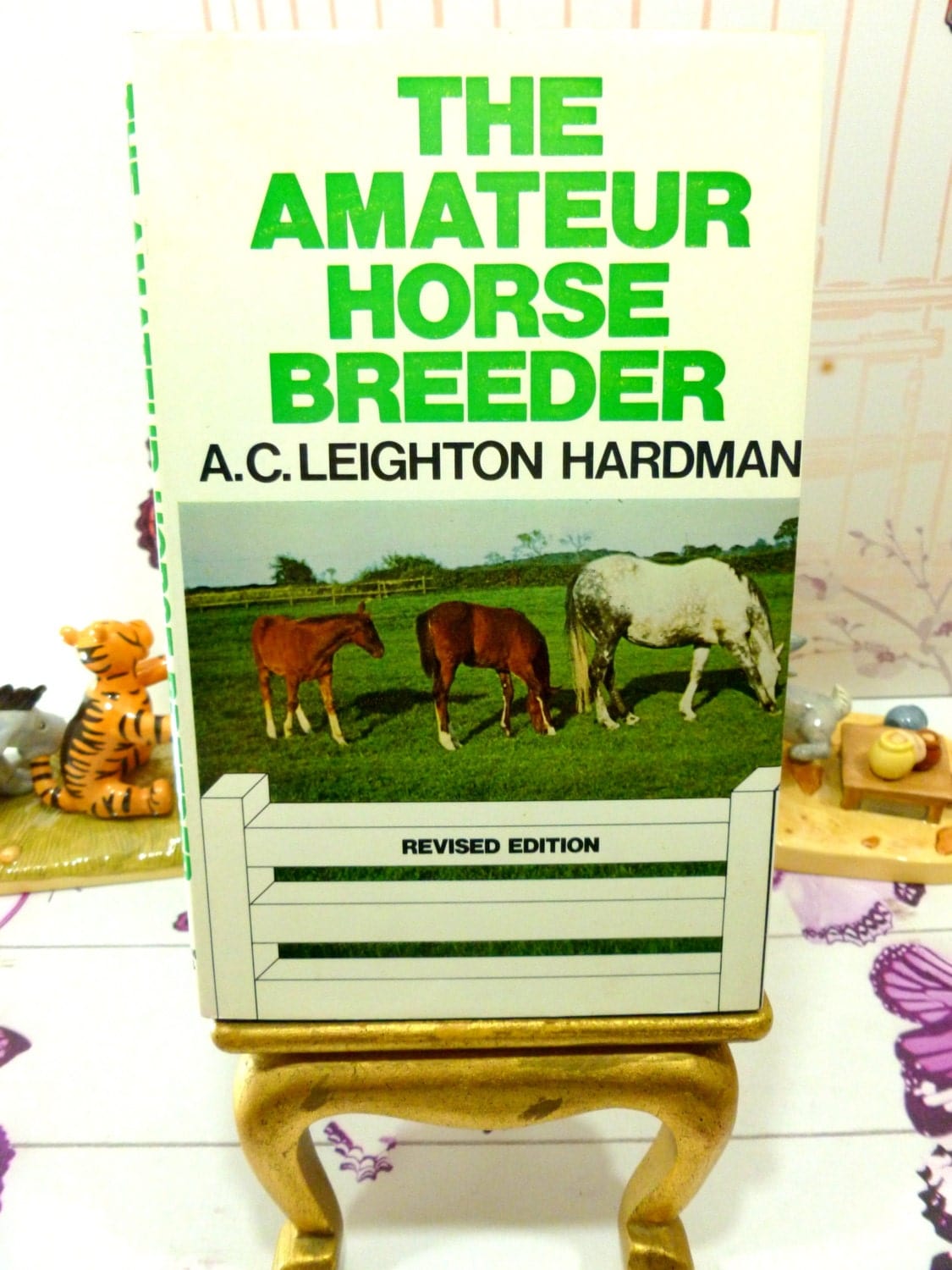 Front cover of The Amateur Horse Breeder vintage Handbook for the Novice Horse Breeder 1974 showing photograph of horse in a field and titles in green. .