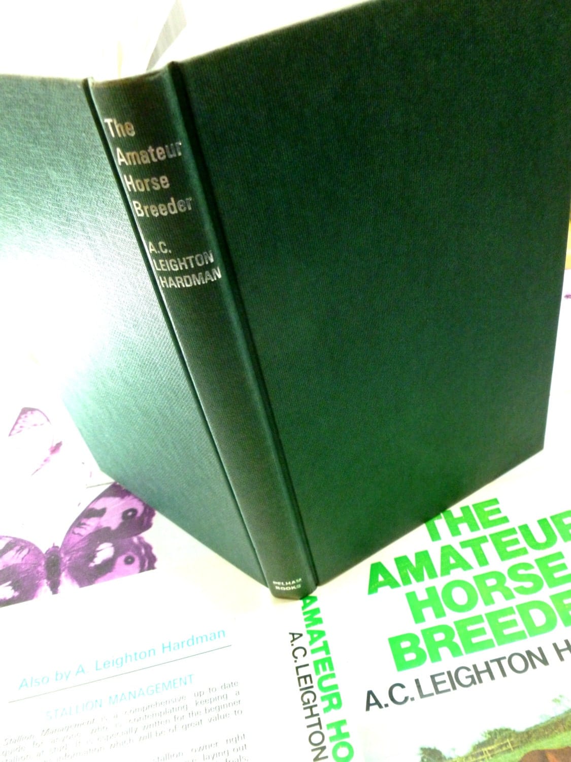 Green cloth covered boards of The Amateur Horse Breeder vintage Handbook for the Novice Horse Breeder 1974 showing silver titles.