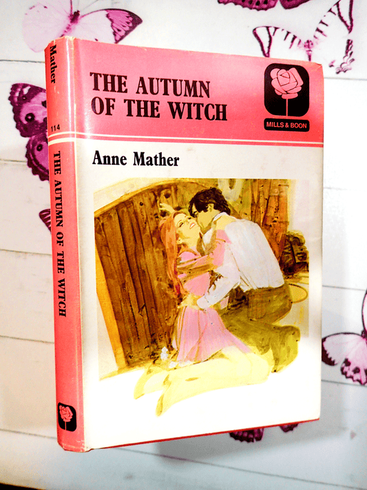 Pink front cover showing a man embracing a woman of Autumn of the Witch First Edition vintage hardback Mills and Boon Book.
