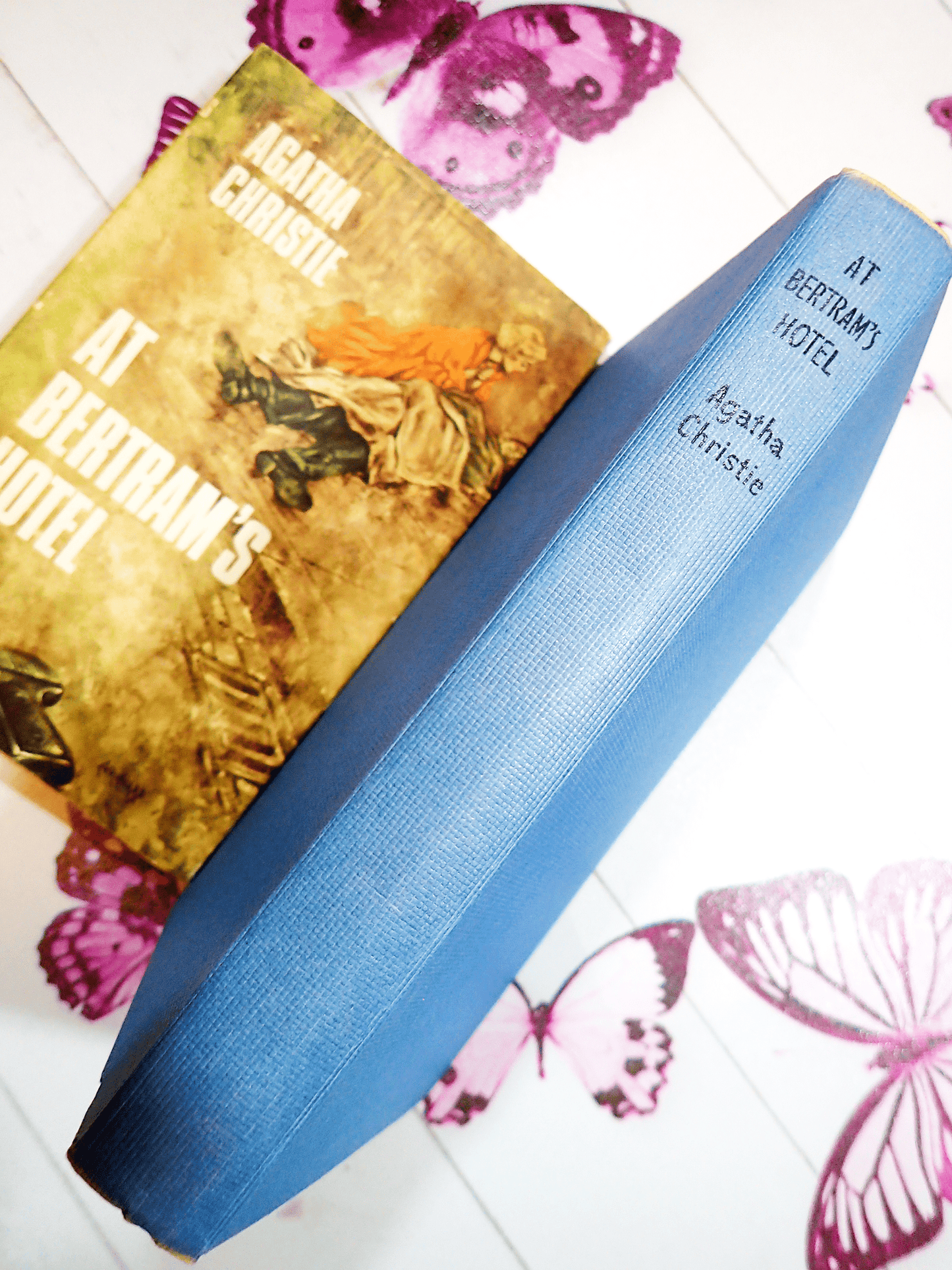 Agatha Christie's At Bertrams Hotel Vintage Book Classic Crime Fiction 1950's Hardback showing blue boards and spine with black titles and dustjacket in the background.