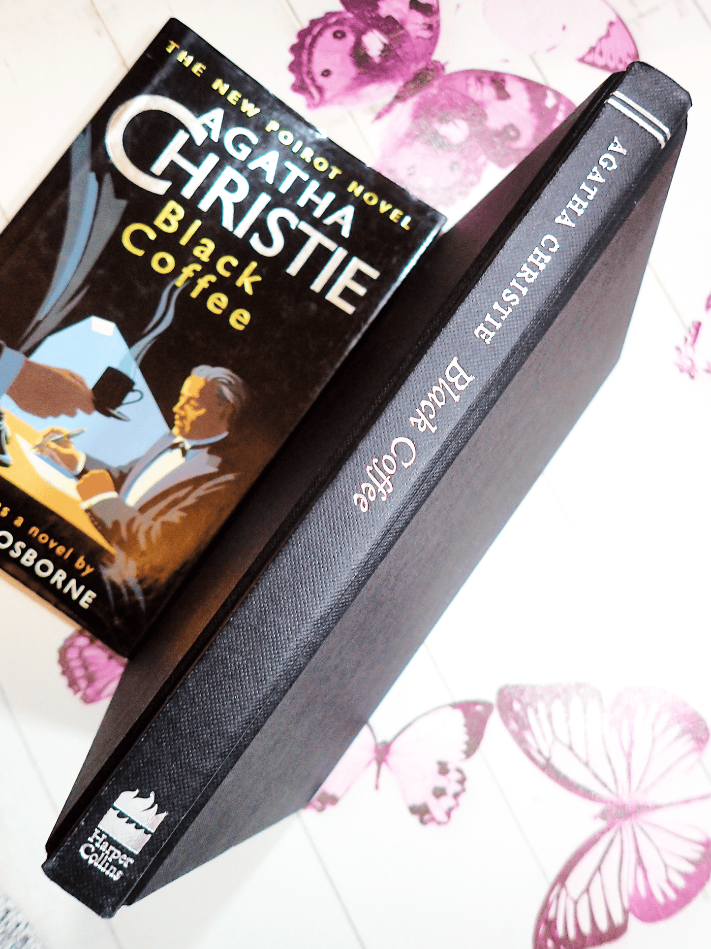 Spine of Agatha Christie Black Coffee Vintage Book Poirot Play Adapted by Charles Osborne with silver titles on black boards with the dust jacket next to it.