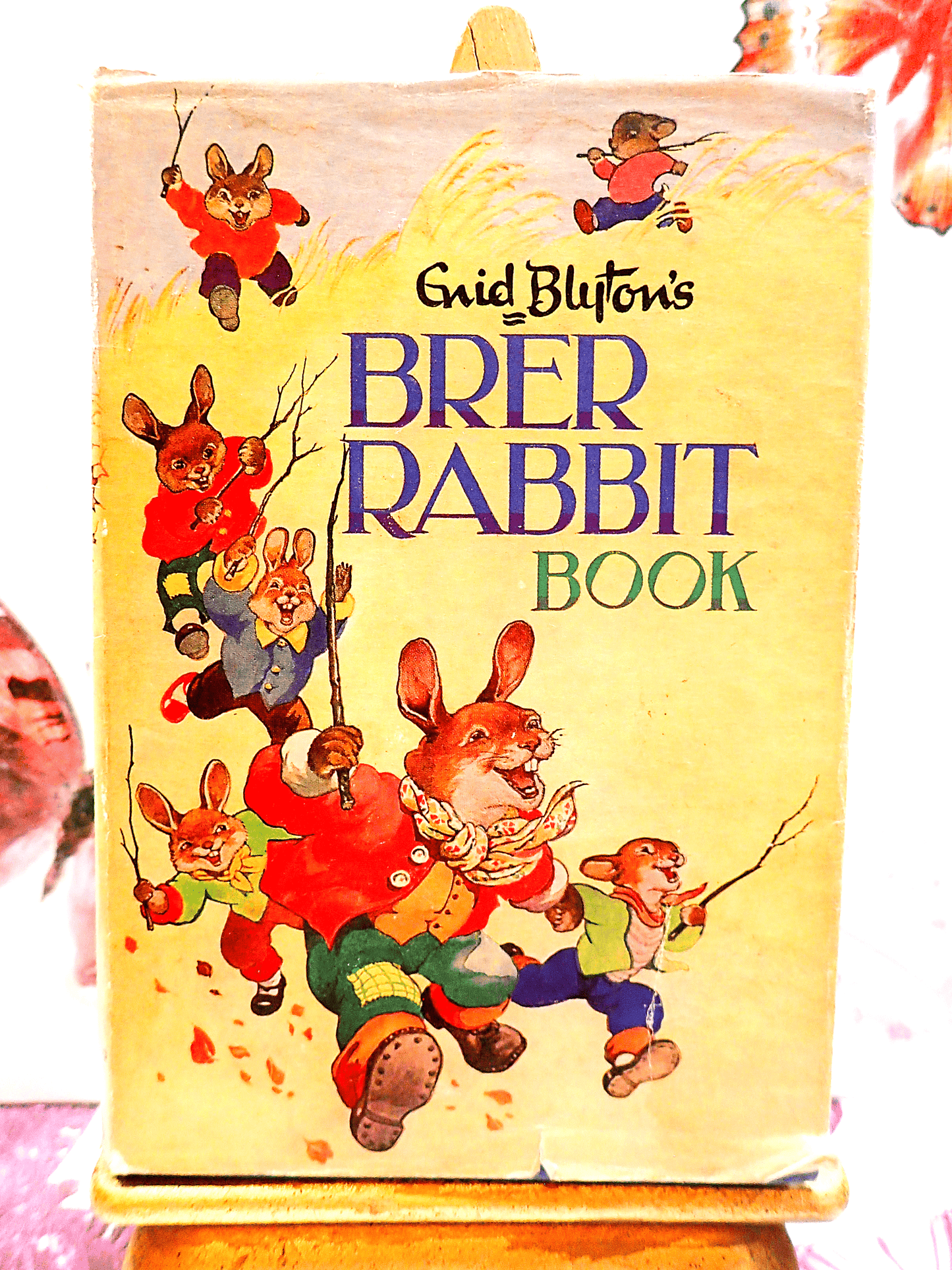 Front Cover of Enid Blyton's Brer Rabbit Book Vintage Childrens Bedtime Stories First Edition 1963 showing lots of dressed Bunnies running in a hay field.