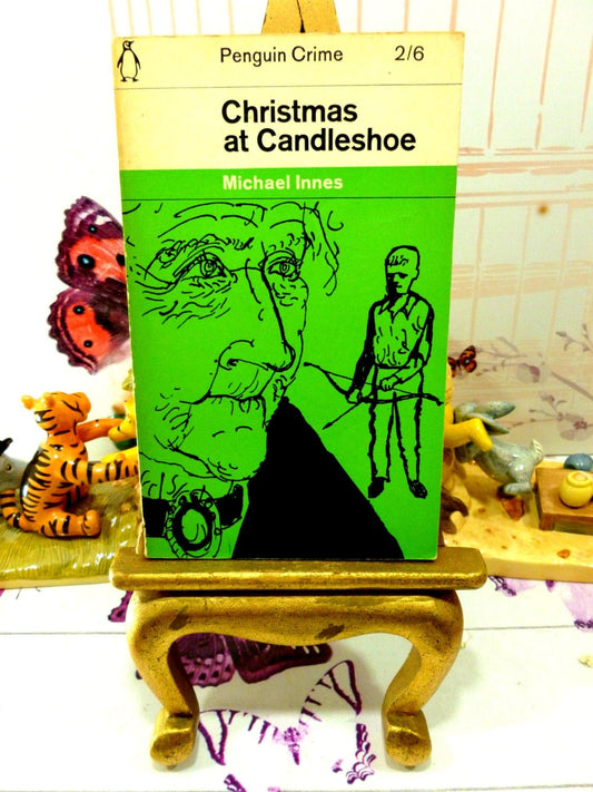 Front cover of Vintage Penguin Paperback Christmas at Candleshoe by Michael Innes First Edition showing a drawing of a man and a boy on a green ground. 