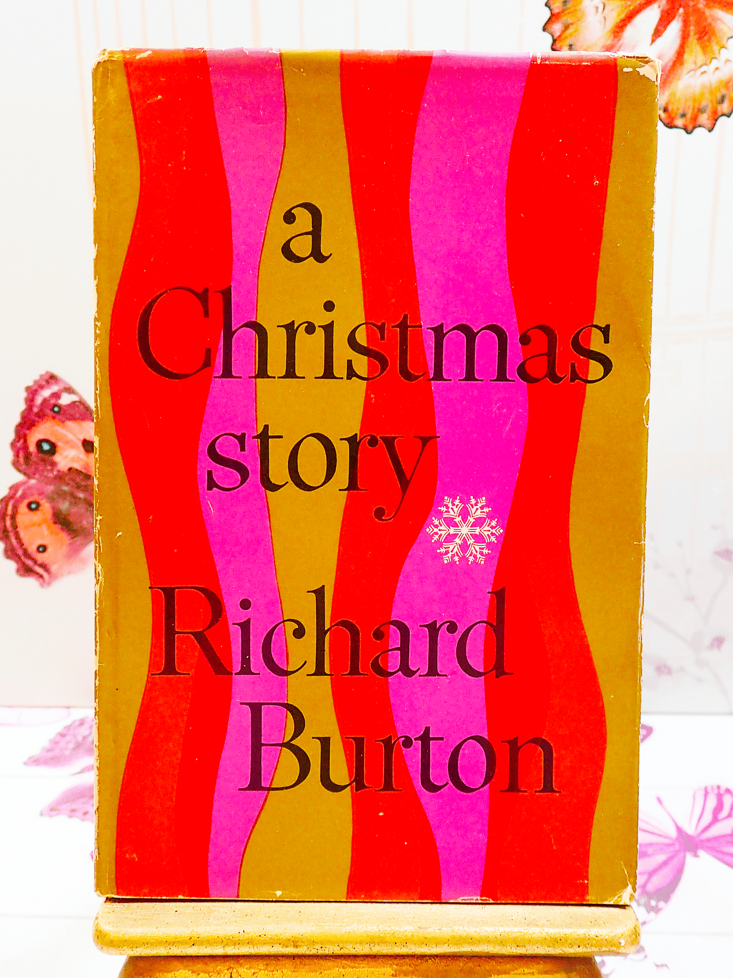 First Edition vintage book, A Christmas Story by Richard Burton with colourful front cover in red and gold showing a snowflake.