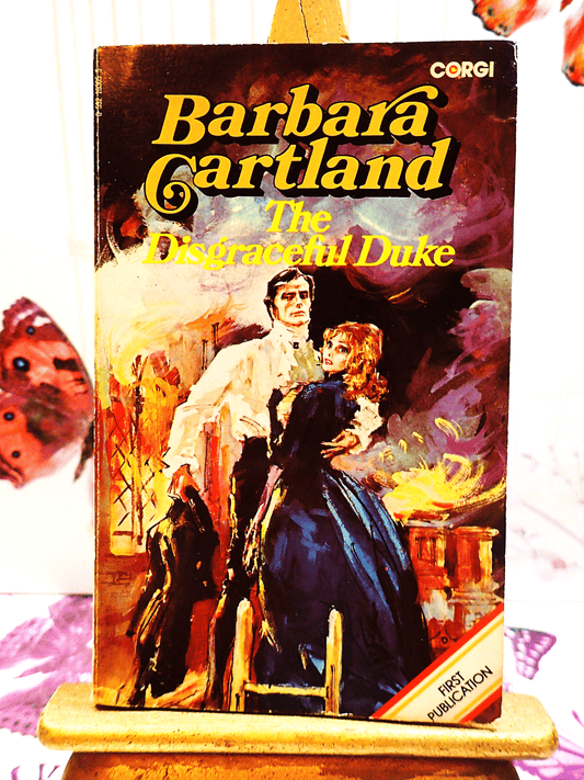 Front cover of The Disgraceful Duke Barbara Cartland Corgi Paperback showing a rakish man embracing a lady in long blue dress. 