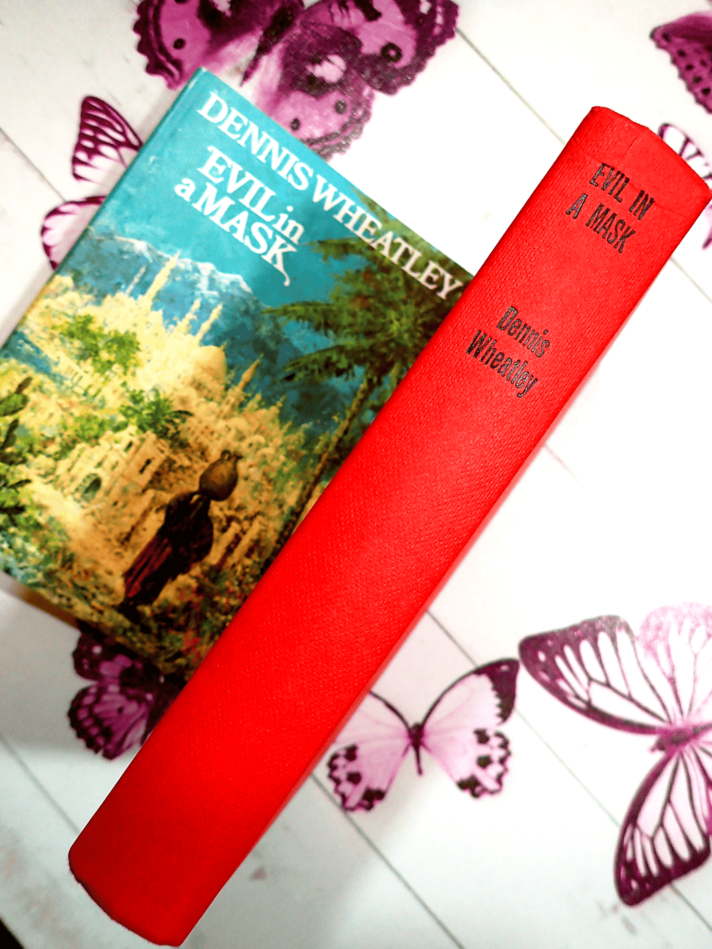 Red boards of Evil in a Mask Dennis Wheatley Vintage Book BCA 1960's showing black titles to the spine.