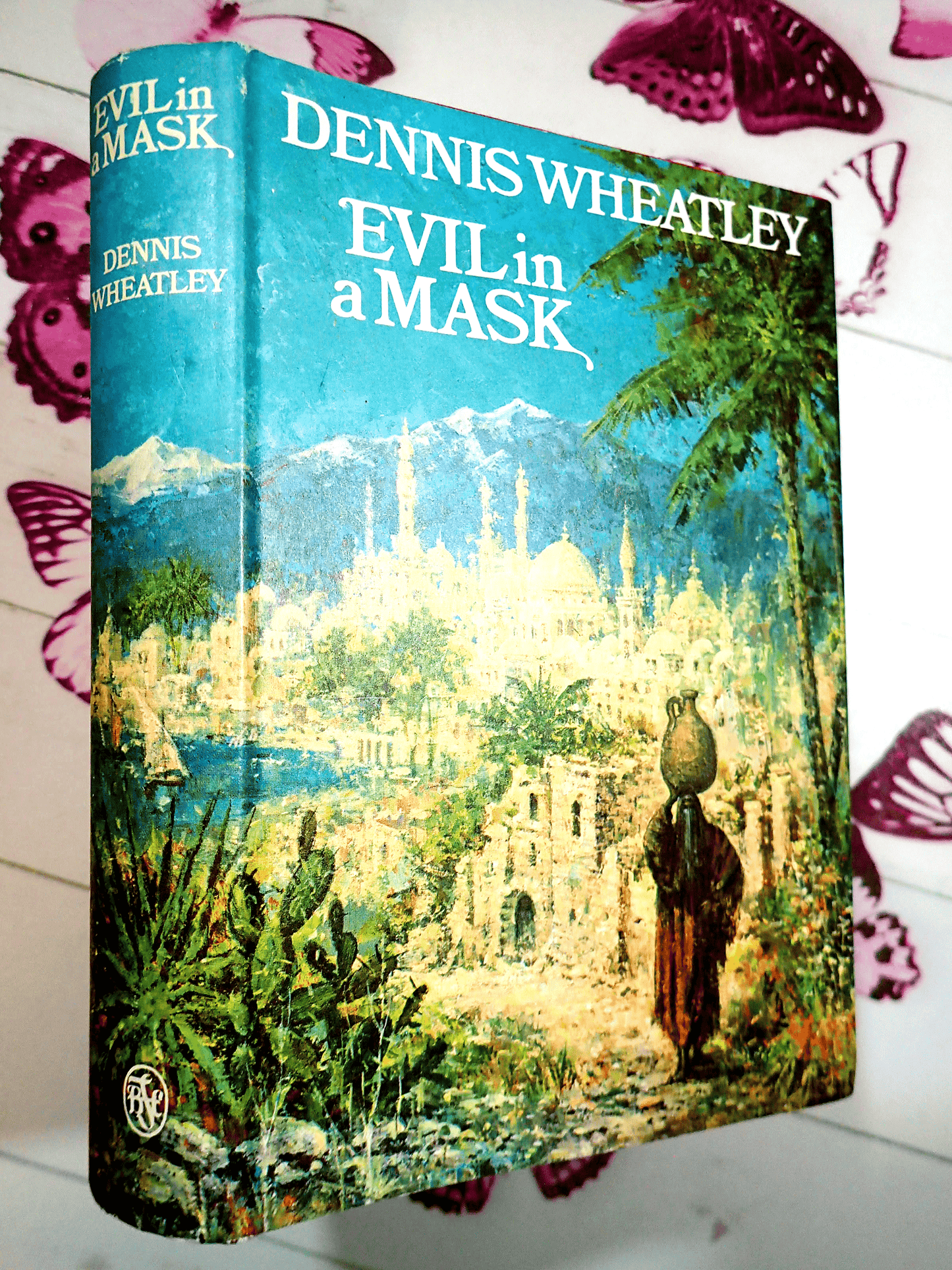 Front cover of Evil in a Mask Dennis Wheatley Vintage Book BCA 1960's Showing a figure walking against an eastern landscape.