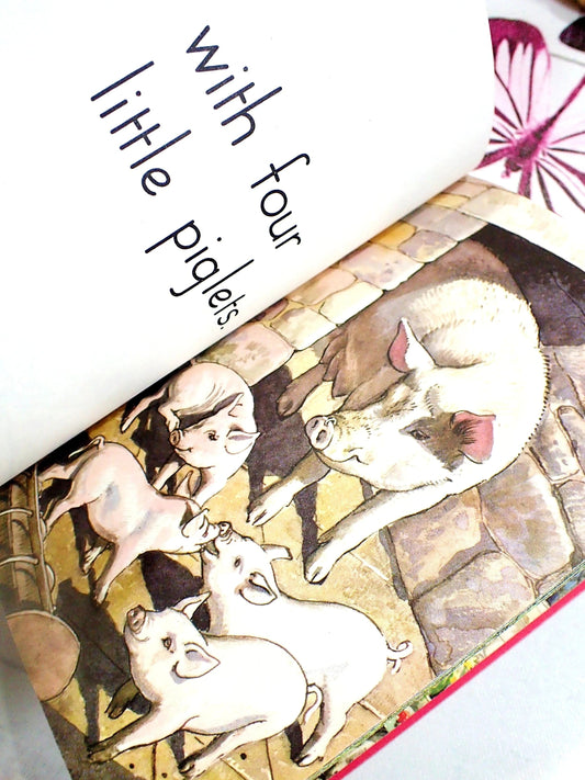 A pig with four little piglets in a farmyard.