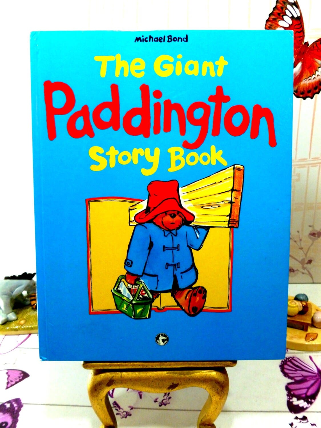 Front Cover of The Giant Paddington Story Book by Michael Bond Paddington Bear First Ed. 1989 showing Paddington Bear carrying some wood and a toolbox.