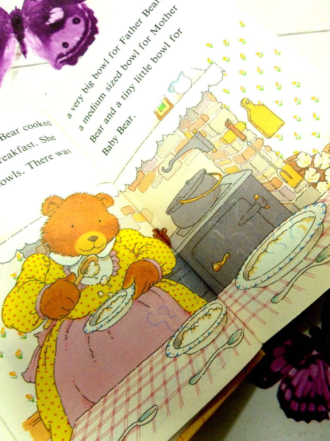 Illustration from vintage Ladybird book showing mother bear making porridge. Goldilocks and the Three Bears. Well Loved Tales.