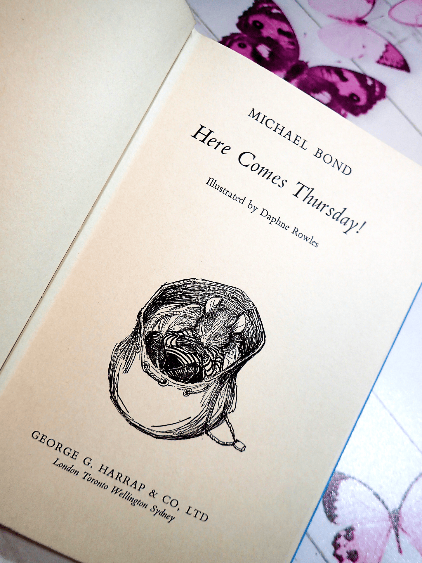 Title page of Here Comes Thursday Michael Bond Vintage Children's Book First Edition 1970's showing illustration by Daphne Rowles of a cute mouse asleep.