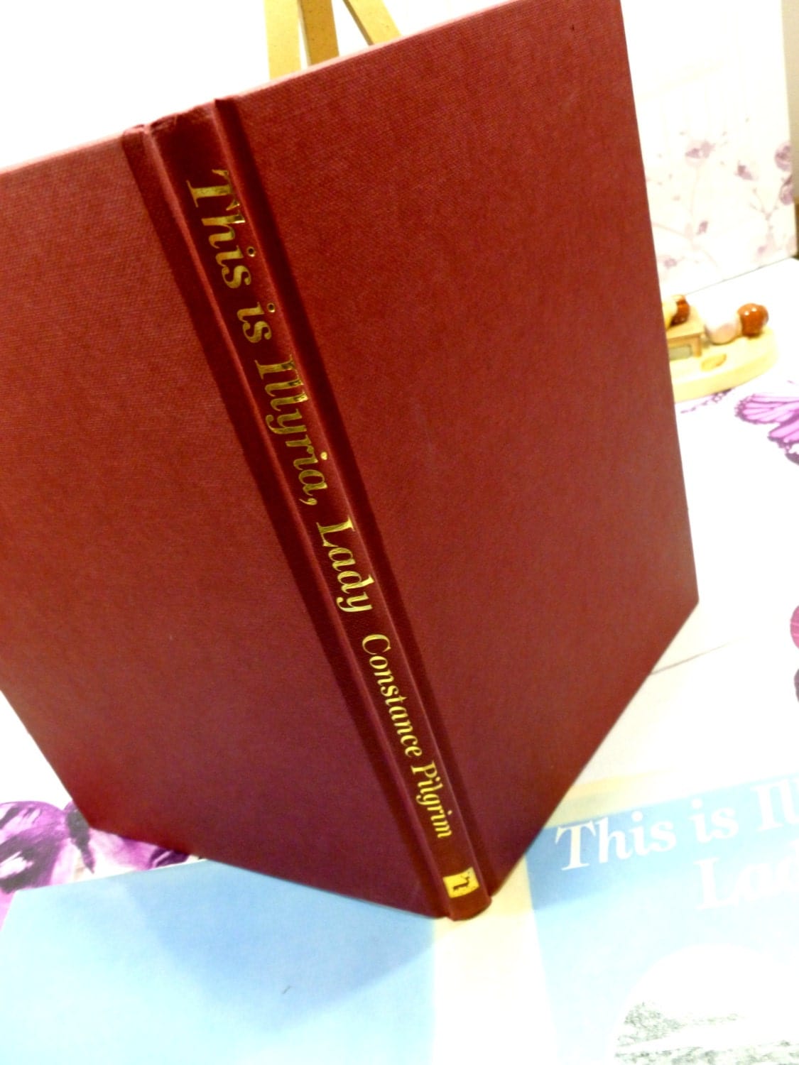 Red cloth bound boards with gilt titles of vintage Jane Austen's Life Hardback Book This is Illyria, First Edition.