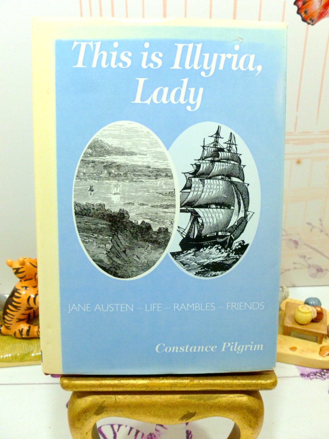 Front cover of Jane Austen's Life Hardback Book This is Illyria, blue ground with vignettes of seascape engravings in black and white.