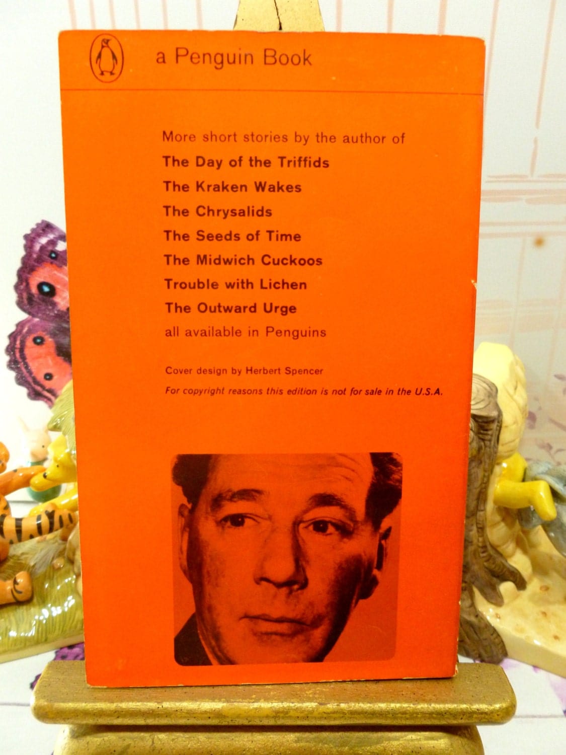 Back cover of Vintage Penguin Orange Paperback John Wyndham First Ed Book Consider Her Ways and Others showing a photo of John Wyndham on an Orange background with list of his other novels.