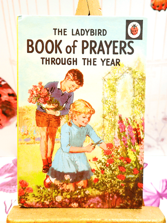 Front cover of The Ladybird Book of Prayers Through the Year for Children Beautifully Illustrated 1970's showing two children tending a garden.