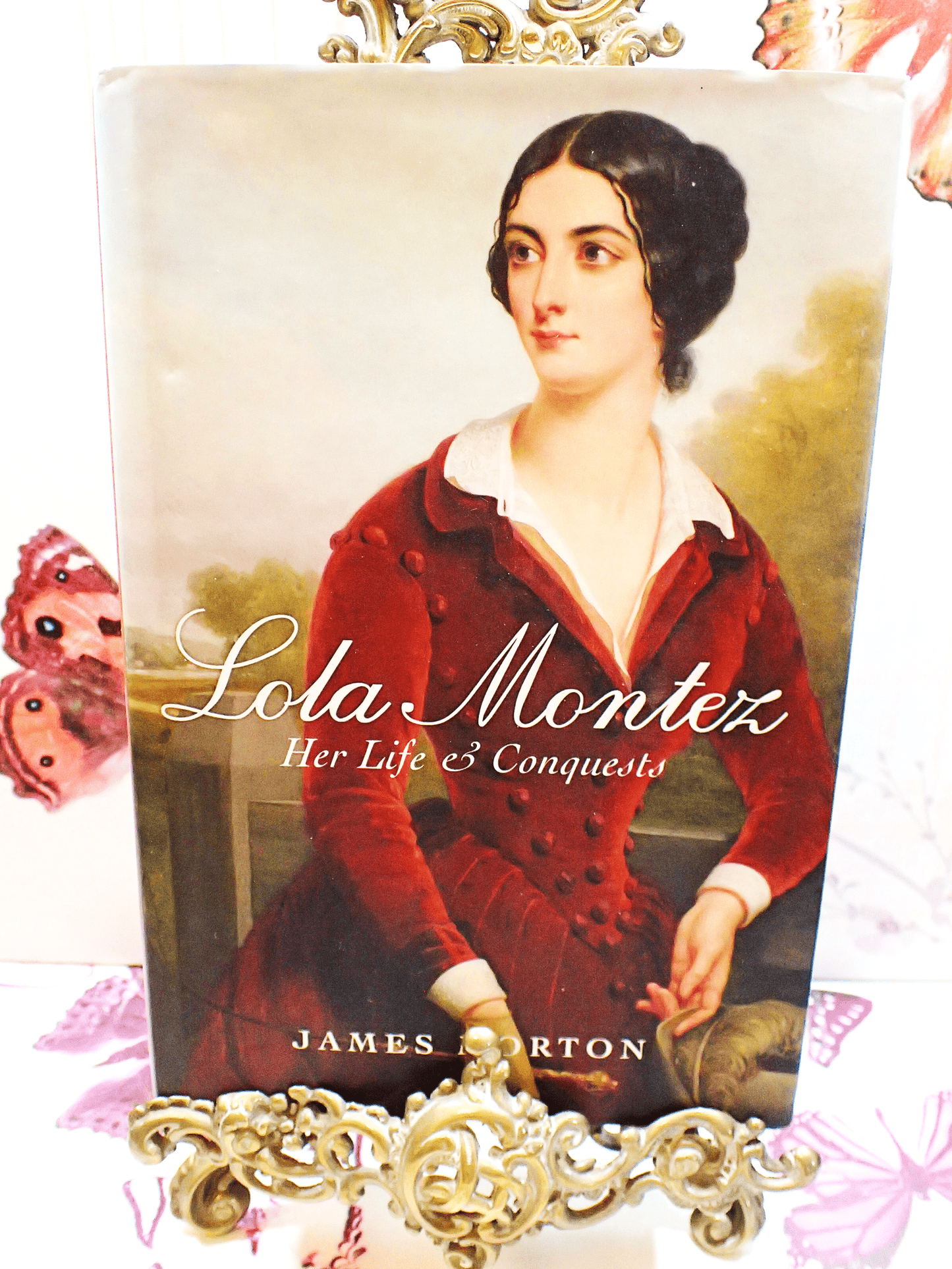 Front cover of Lola Montez Her Life & Conquests by James Morton showing beautiful portrait of Lola Montez in a red velvet gown.