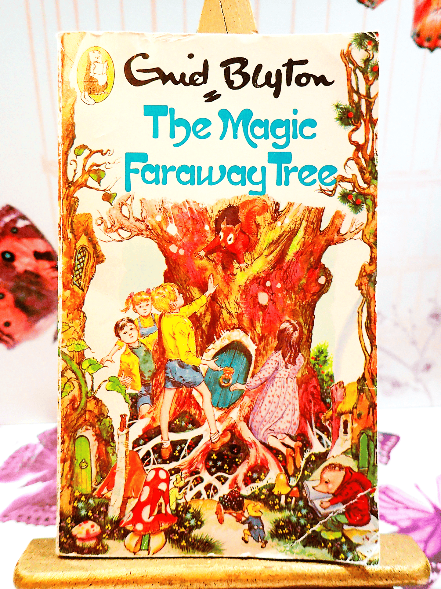Front cover of The Magic Faraway Tree by Enid Blyton Beaver Paperback Vintage Children's Book 1980's showing children in a magical forest with a squirrel in a tree.