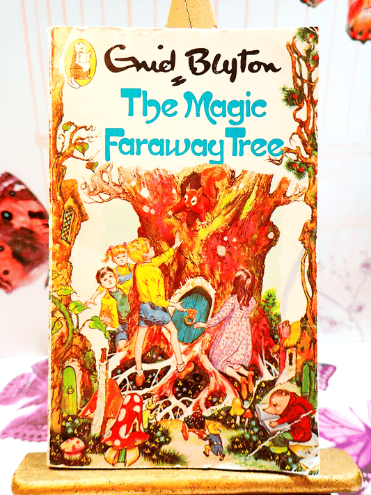 Front cover of The Magic Faraway Tree by Enid Blyton Beaver Paperback Vintage Children's Book 1980's showing children in a magical forest with a squirrel in a tree. 