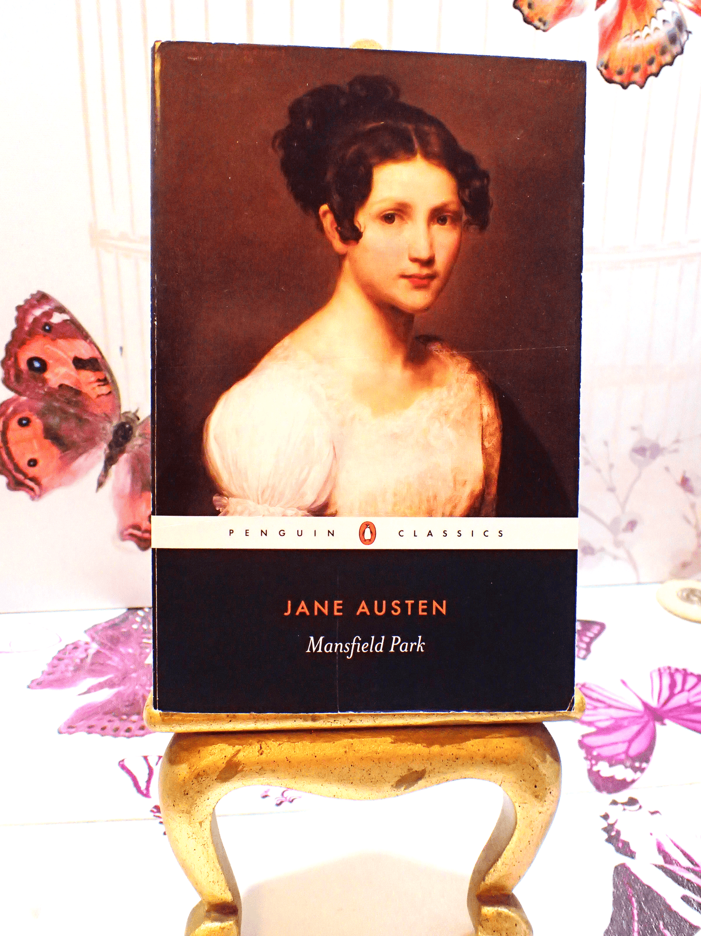 Front cover of Mansfield Park Jane Austen Penguin Classics showing a portrait of a Regency Girl with butterflies in the background.
