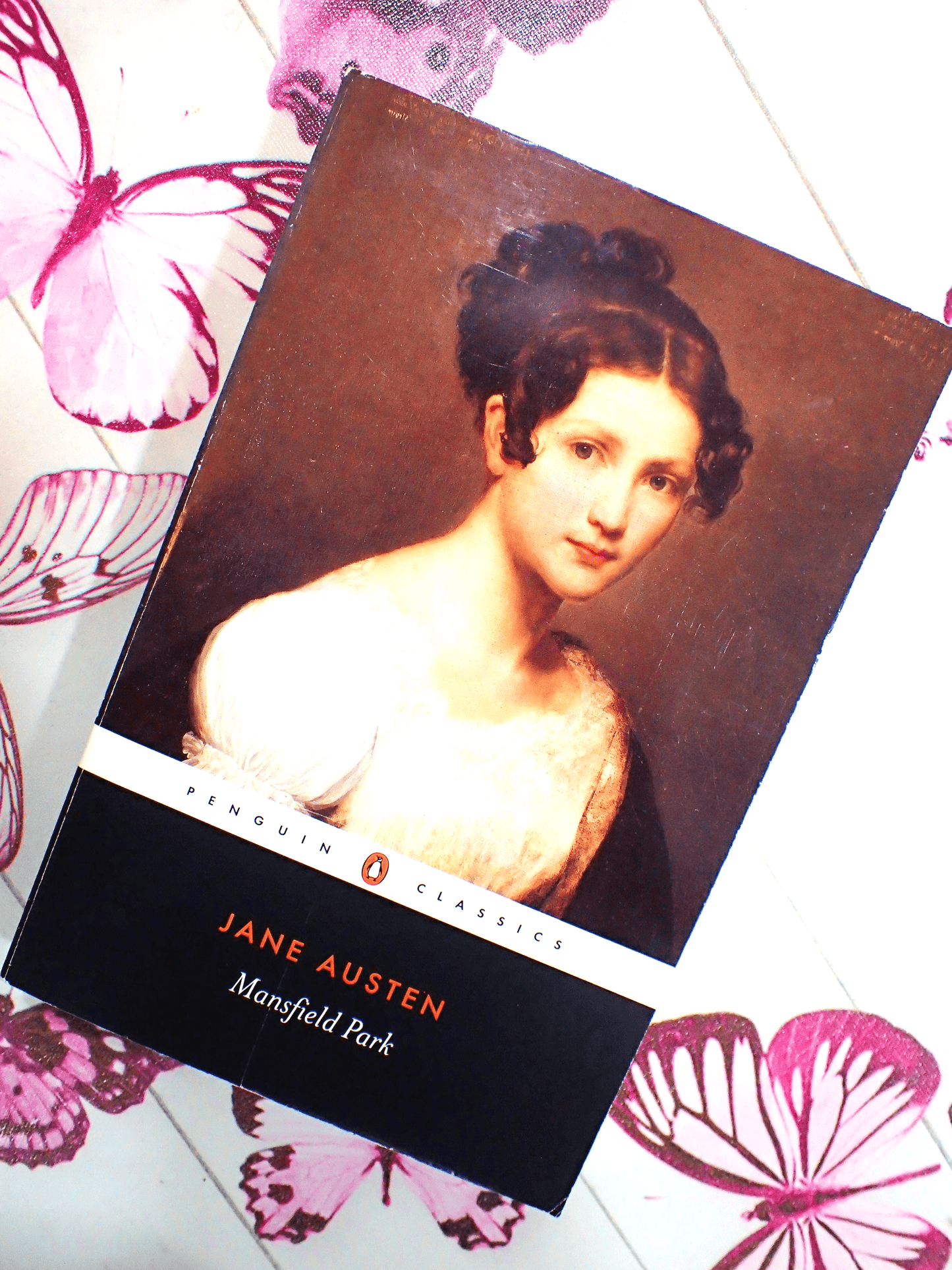 Front cover of Mansfield Park Jane Austen Penguin Classics showing a portrait of a Regency Girl with butterflies in the background.