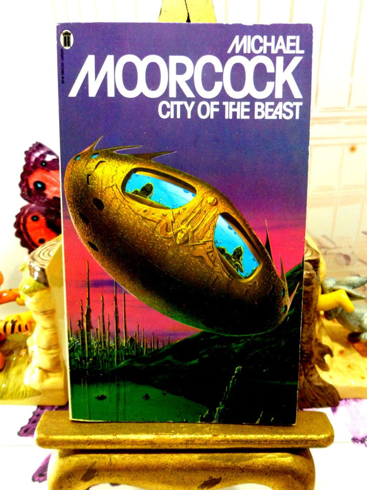 Front cover of Michael Moorcock Vintage Sci Fi Paperback Book 1970s City of the Beast Warriors of Mars Martian Trilogy showing weird spaceship with bug eye windows. 