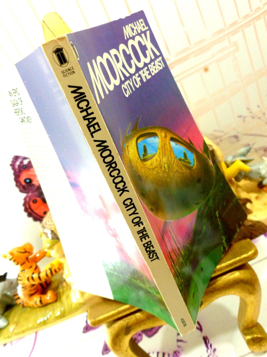 Front cover of Michael Moorcock Vintage Sci Fi Paperback Book 1970s City of the Beast Warriors of Mars Martian Trilogy showing weird spaceship with bug eye windows and black titles against a white spine.