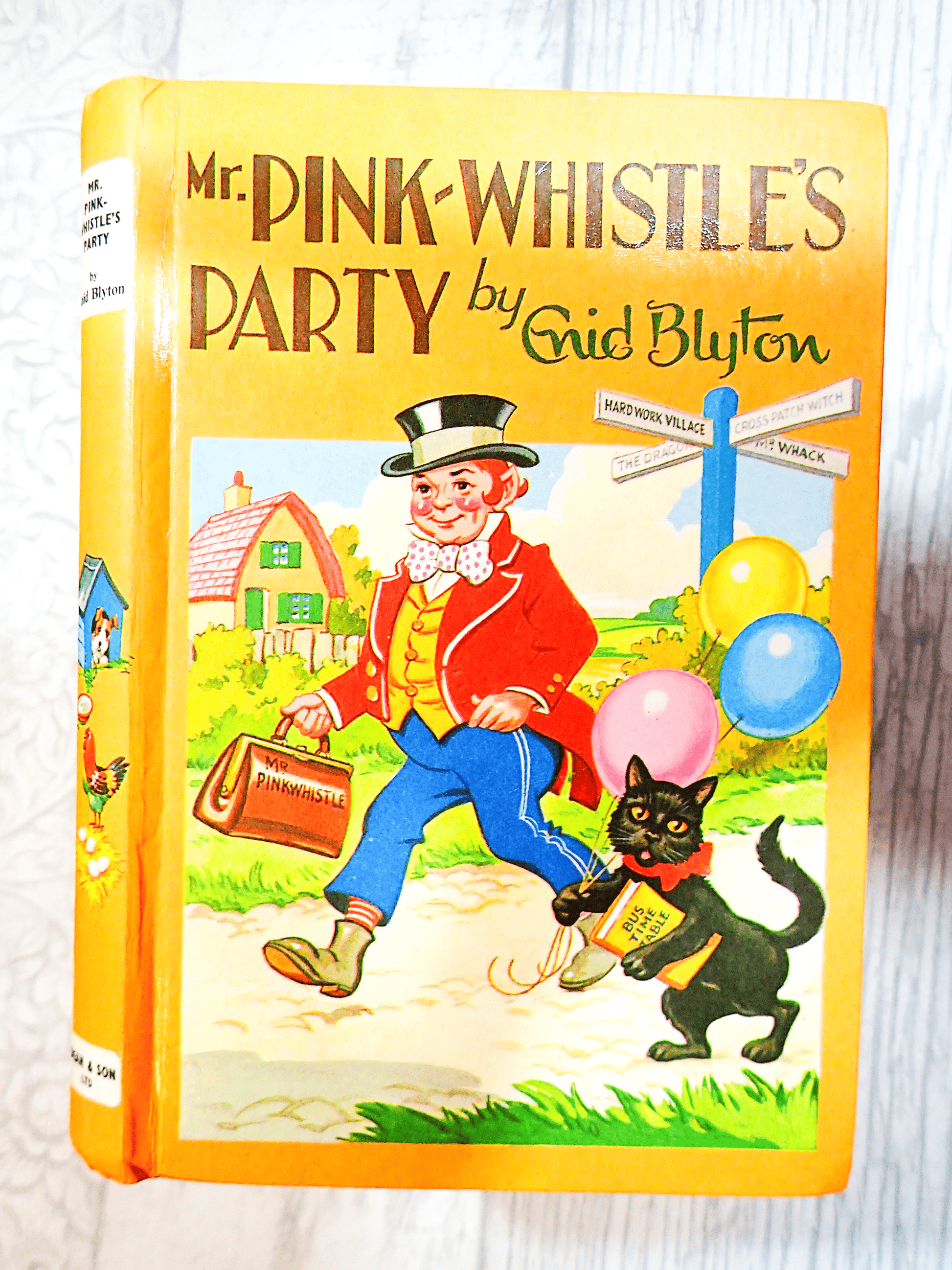 Front Cover of Mr Pinkwhistles Party by Enid Blyton Vintage Children's book 1970's Hardback Bedtime Stories showing Mr Pinkwhistle wearing a funny suit walking with his black cat against a light background.
