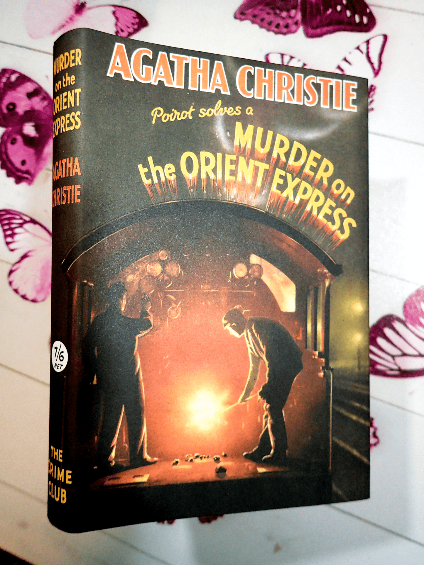Front cover of Murder on the Orient Express Agatha Christie Facsimile Vintage Book showing a man shovelling coal into a train furnace. 