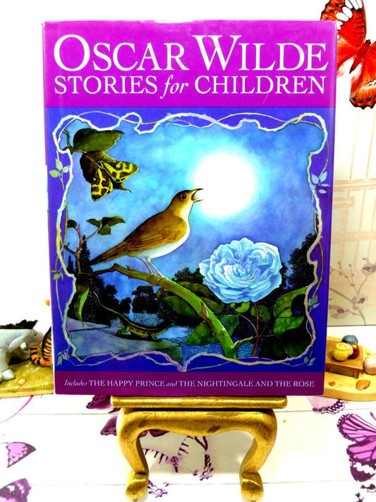 Front cover of Oscar Wilde Fairy Stories for Children inc the Happy Prince Vintage Fairy tale Book showing a nightingale singing against a blue and purple background. 