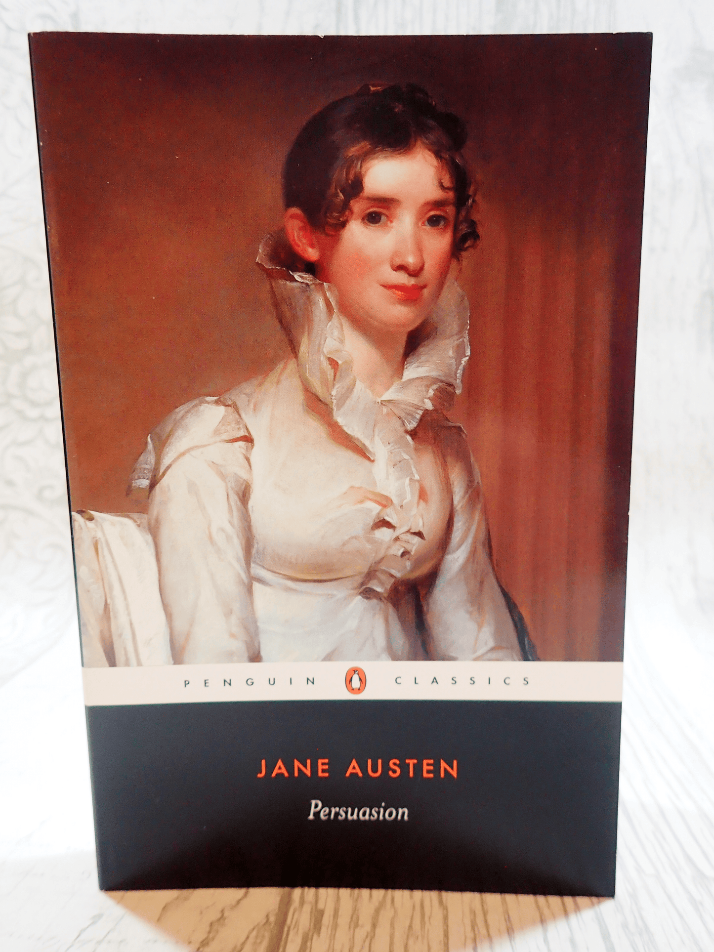 Front cover of Penguin Classic Paperback Persuasion Jane Austen showing a lady in Regency Dress against a light background.