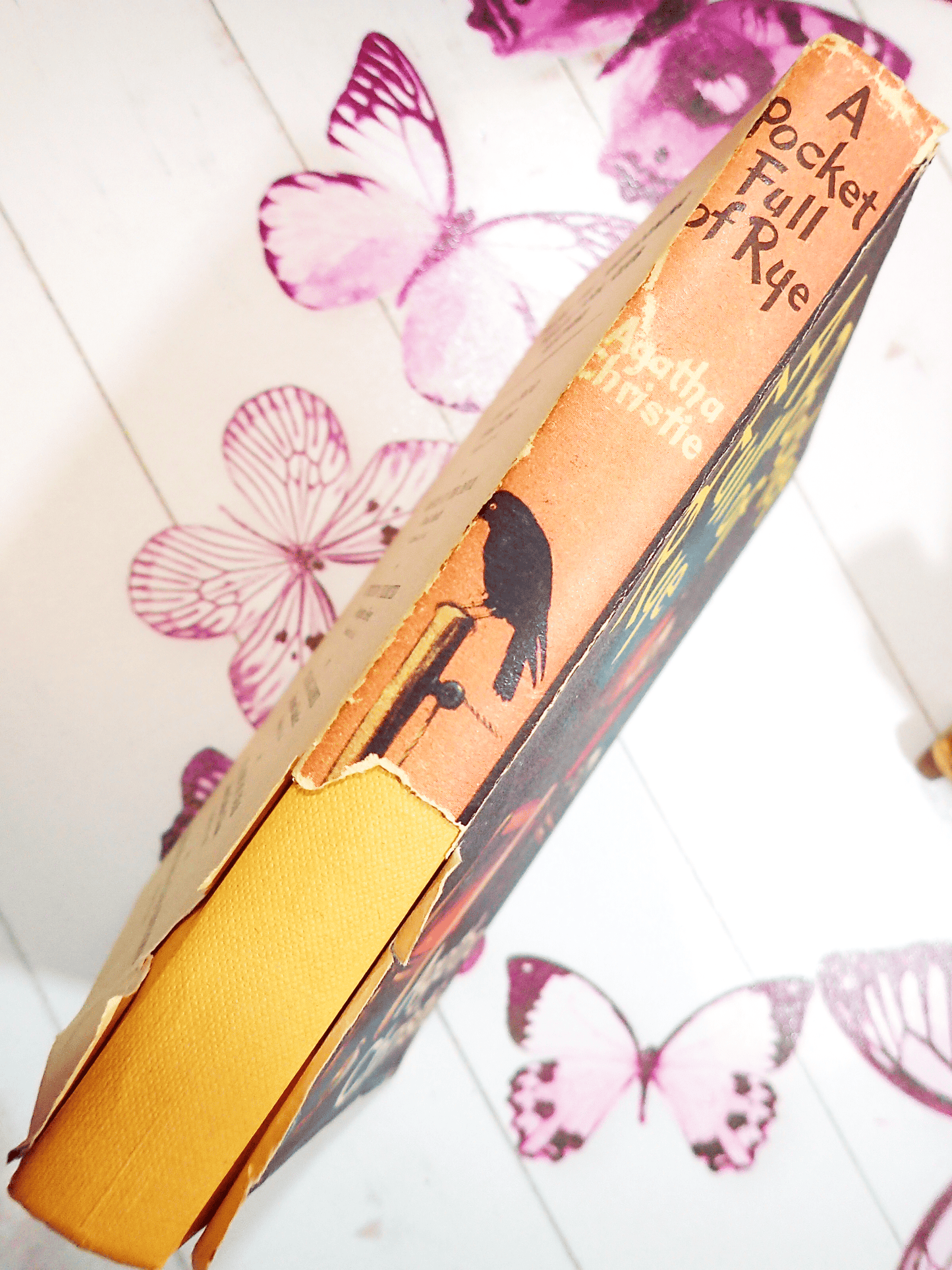 A Pocketful of Rye Agatha Christie Vintage Thriller Book Club First Edition 1954 showing dust jacket with section missing from bottom third of the spine with titles and vignette of a bird.
