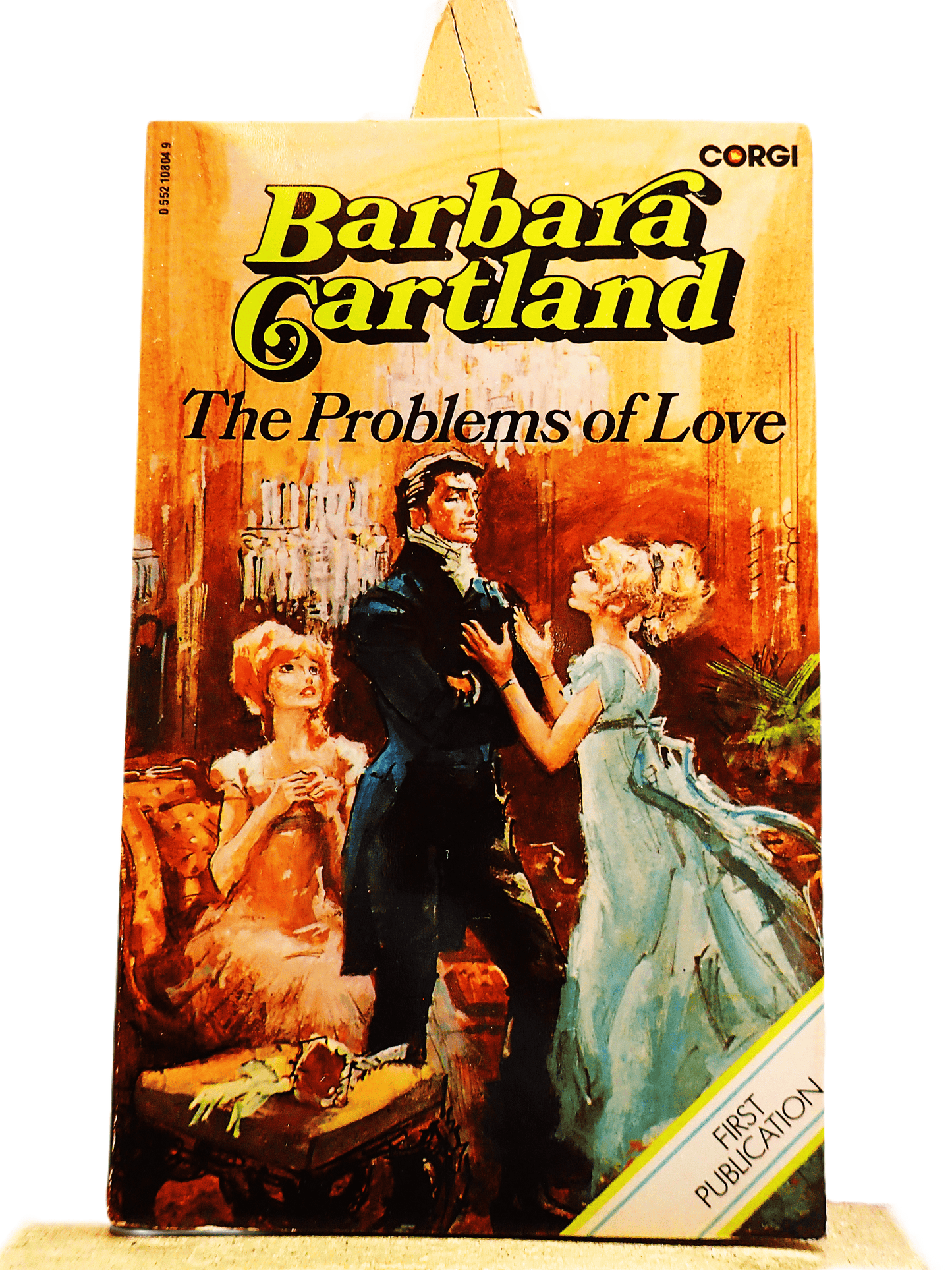 Front cover of The Problems of Love Barbara Cartland Corgi first edition showing a pretty woman in a blue dress pleading with a handsome man.