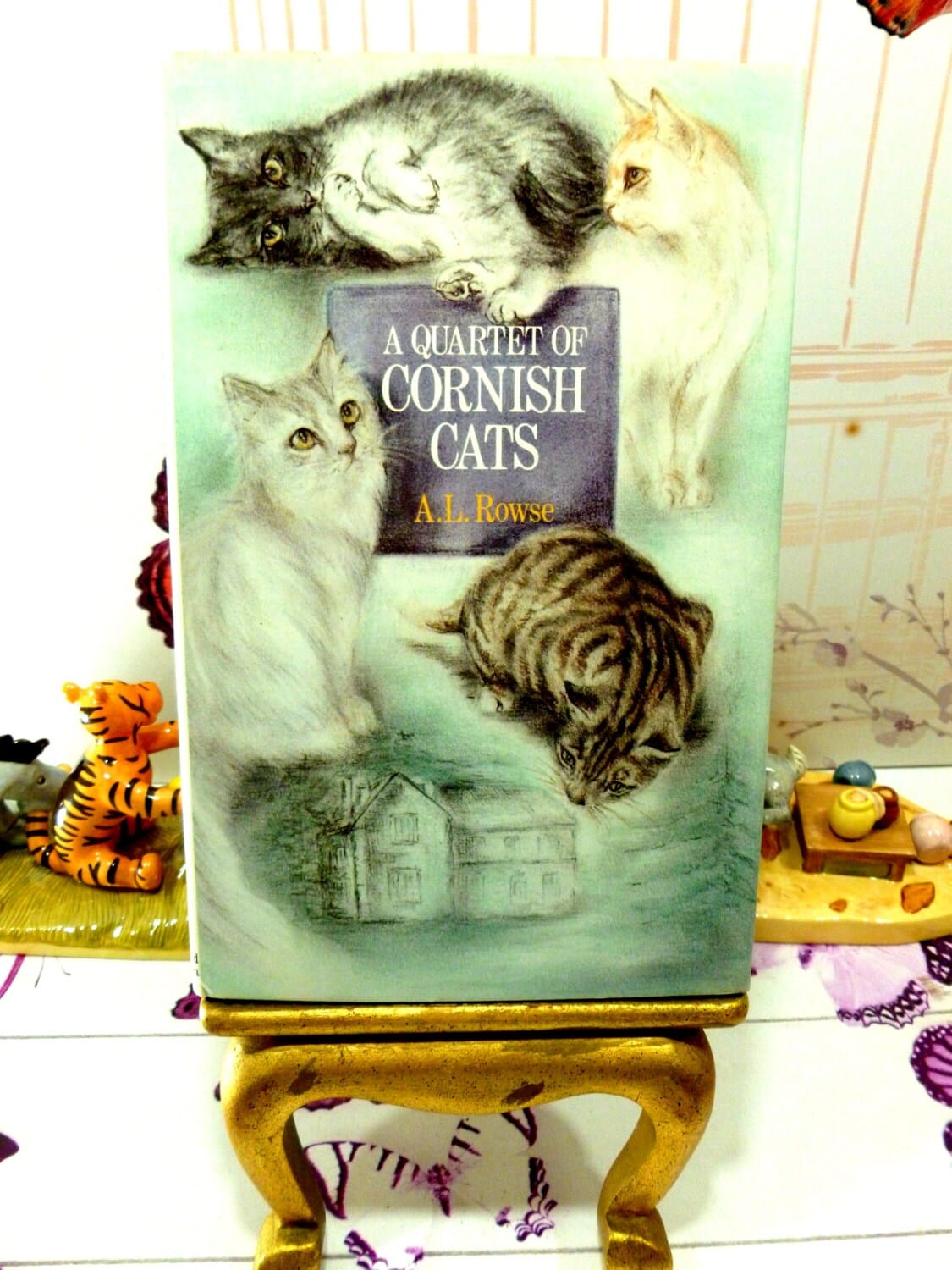Illustrated front cover of vintage book A Quartet of Cornish Cats showing four adorable cats illustrated in a painterly style.