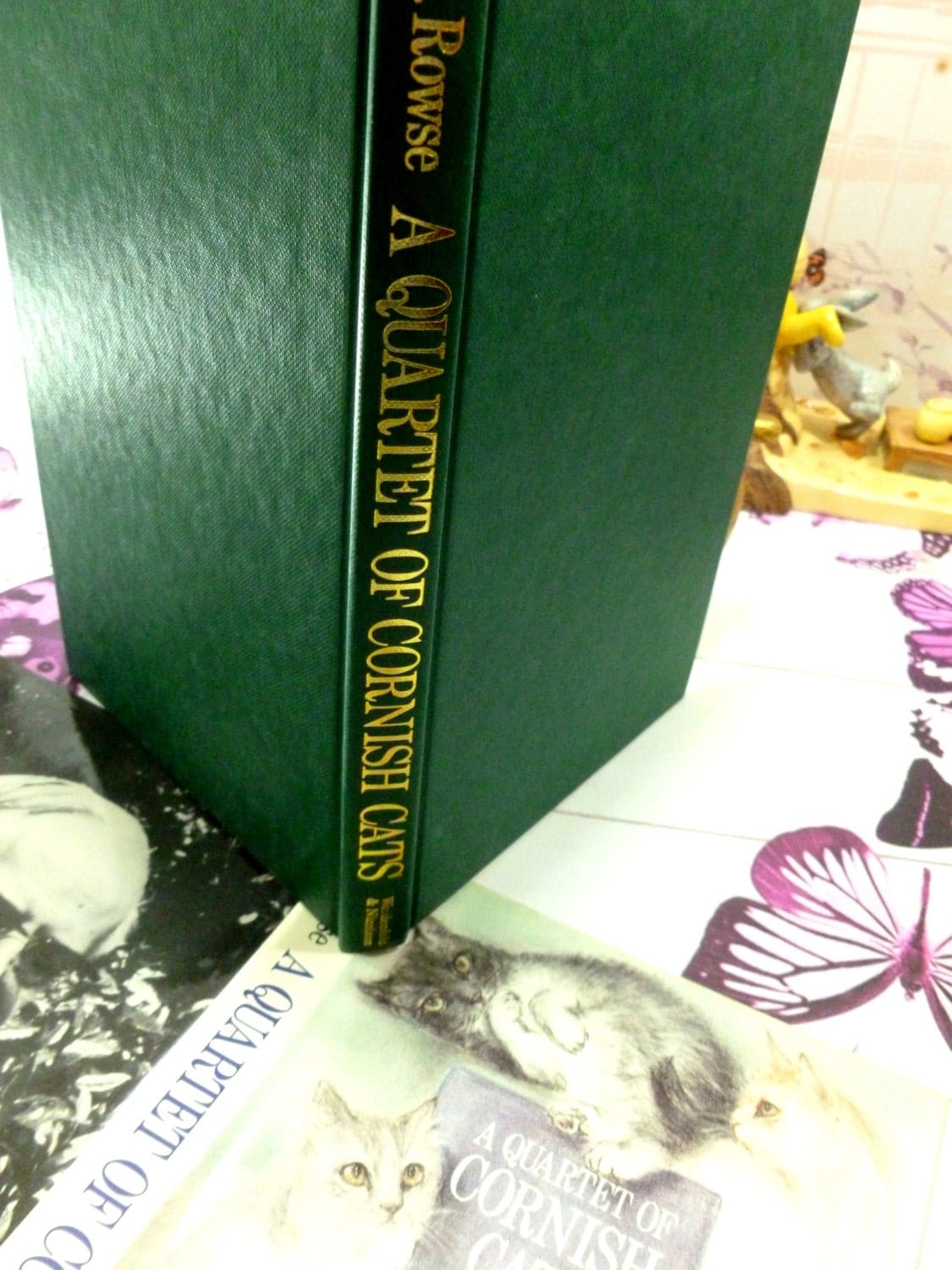 A Quartet of Cornish Cats first edition hardback book with green cloth binding and gilt titles.