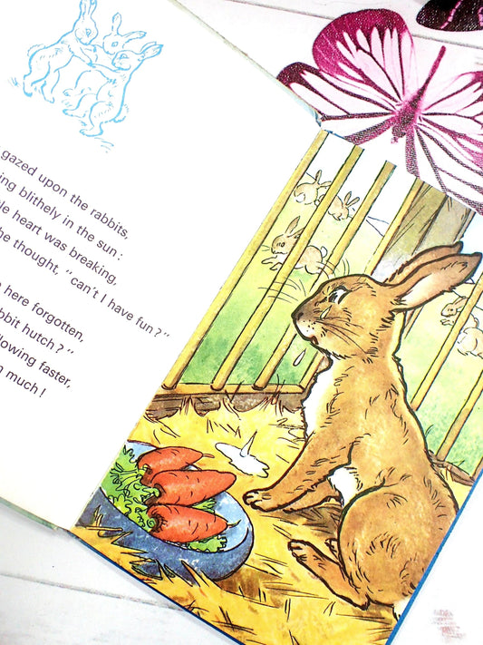 Rabbit in a cage with carrots.