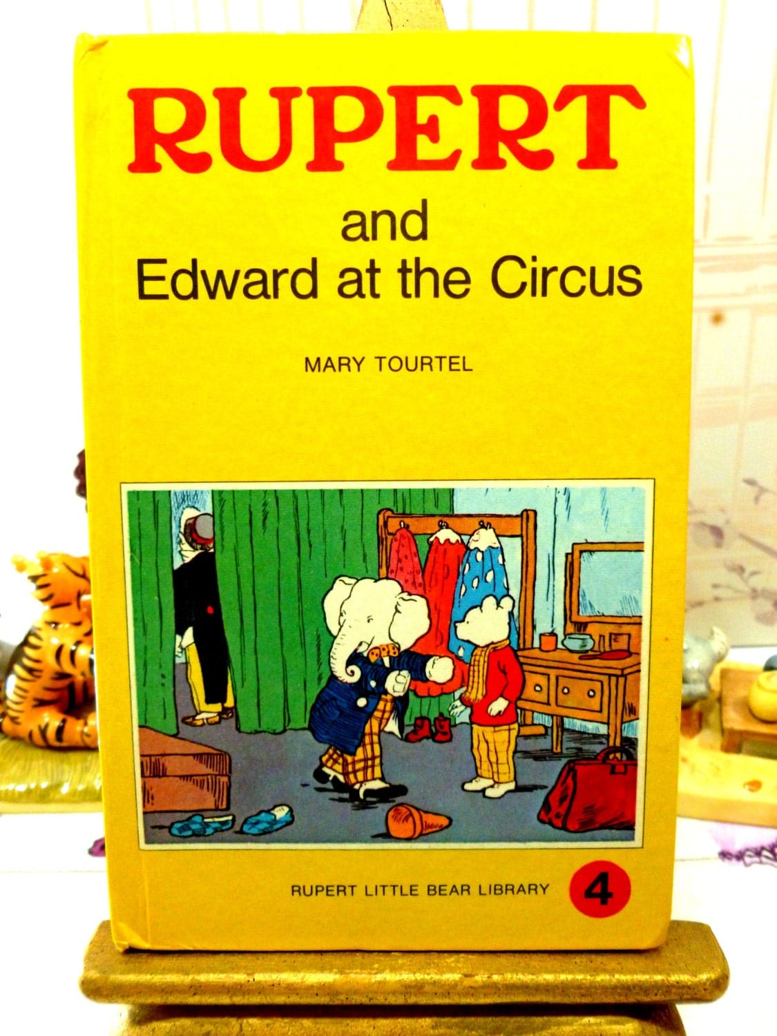 Front cover of yellow vintage book Rupert and Edward at the Circus Mary Tourtel Little Bear Library number 4 1970s first edition showing Rupert and Edward the Elephant.