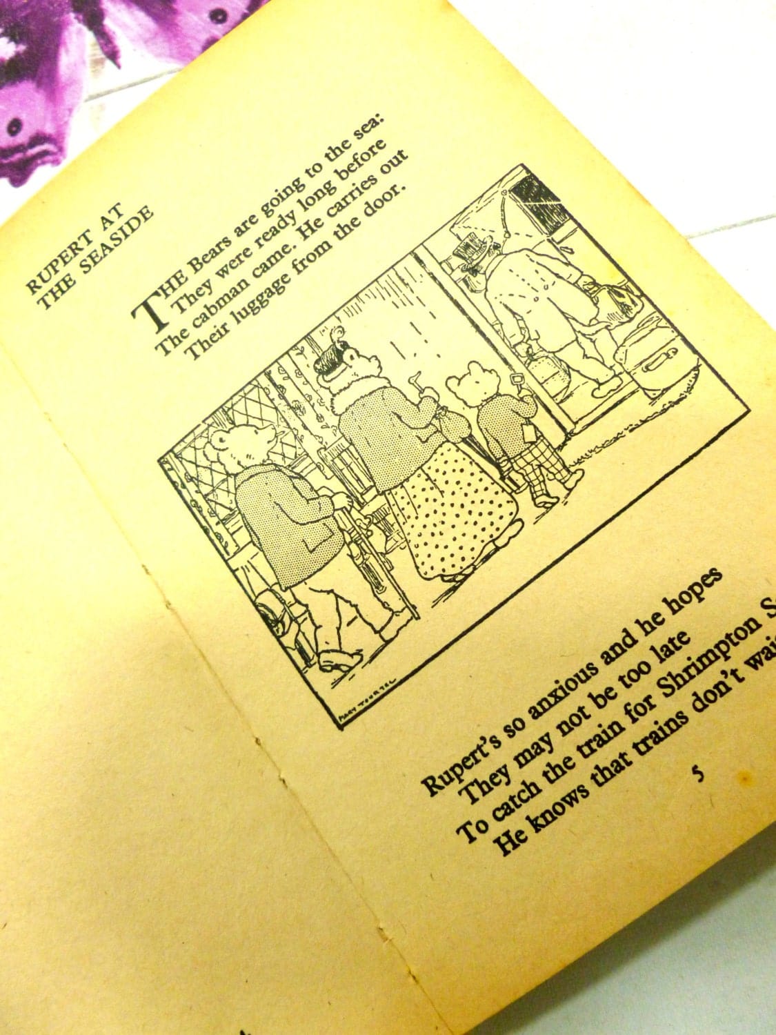 First page of Rupert at the Seaside showing Mrs Bear getting on a train with Ruper and his bucket and spade.