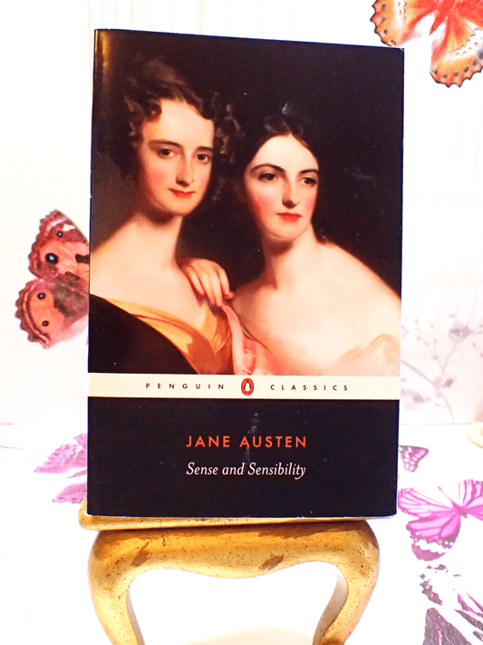 Front cover of paperback book Penguin Classics Sense and Sensibility Jane Austen showing portrait of two Regency ladies. 