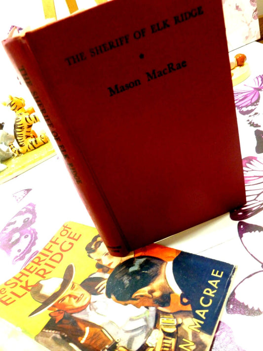 Red coloured boards with black titles on top of dust jacket of book showing the Sheriff of Elk Ridge by Mason Macrae 1st Edition Cowboy Western Pulp Fiction Hardback 1930s Classic Tale of the Old West.