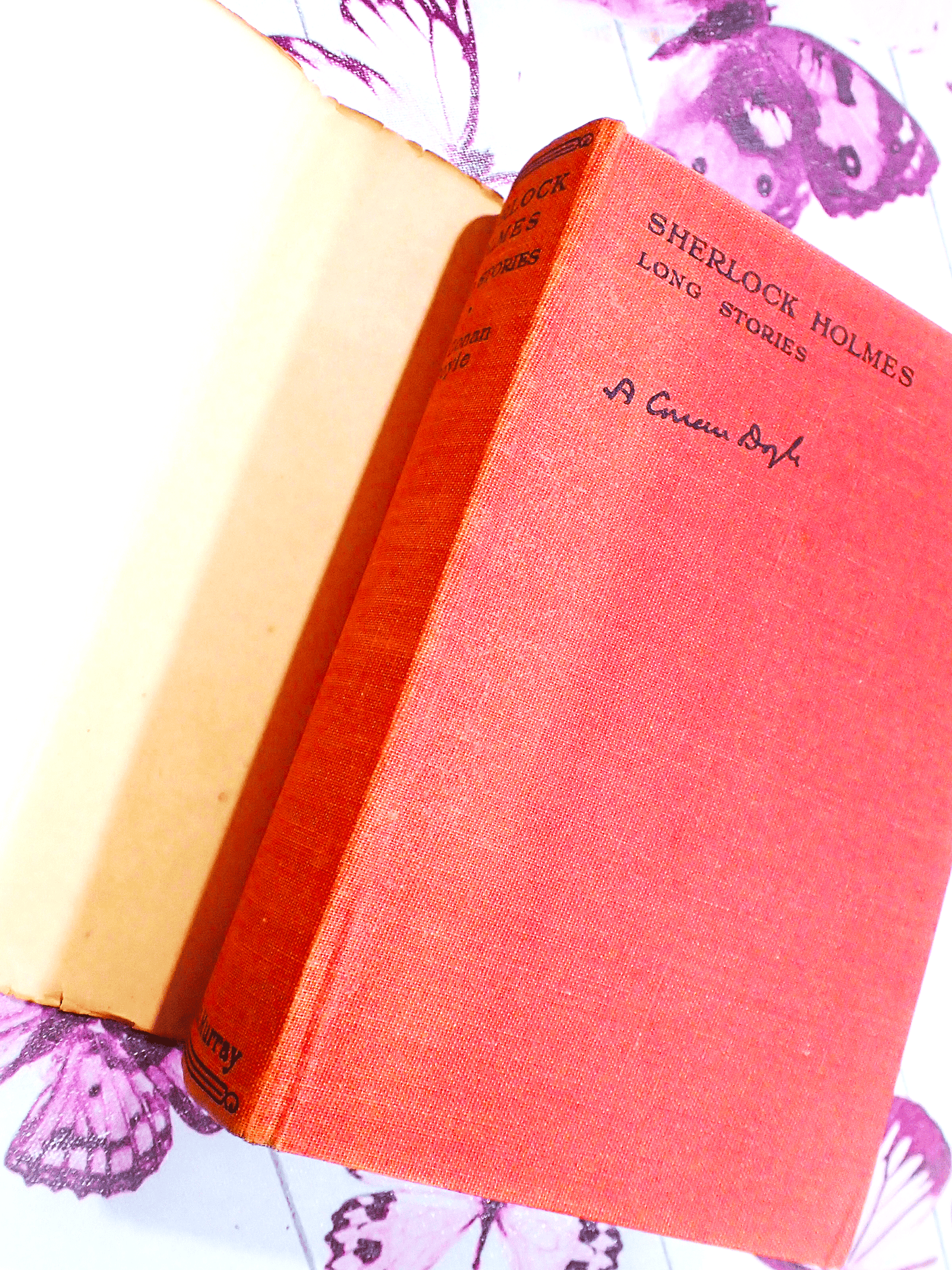 Red cloth boards of Sherlock Holmes Long Stories Arthur Conan Doyle Hound of Baskervilles Scarce Jacket showing black titles.