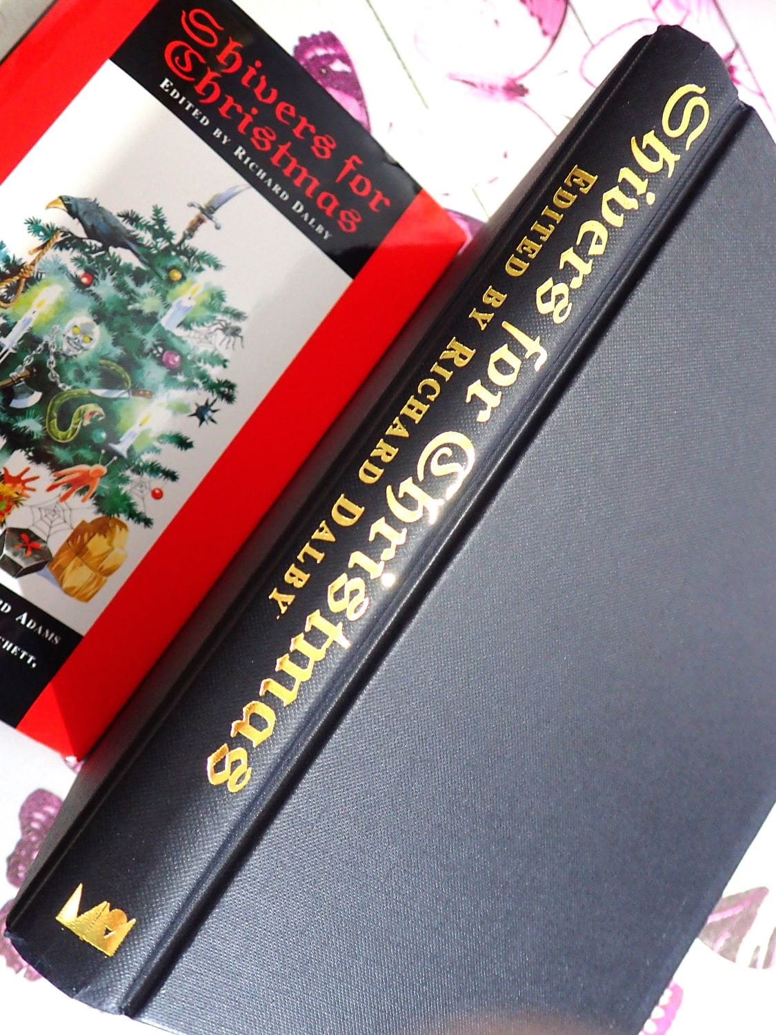 Black binding and gilt titles of vintage first edition book of ghost stories Shivers for Christmas by Richard Dalby
