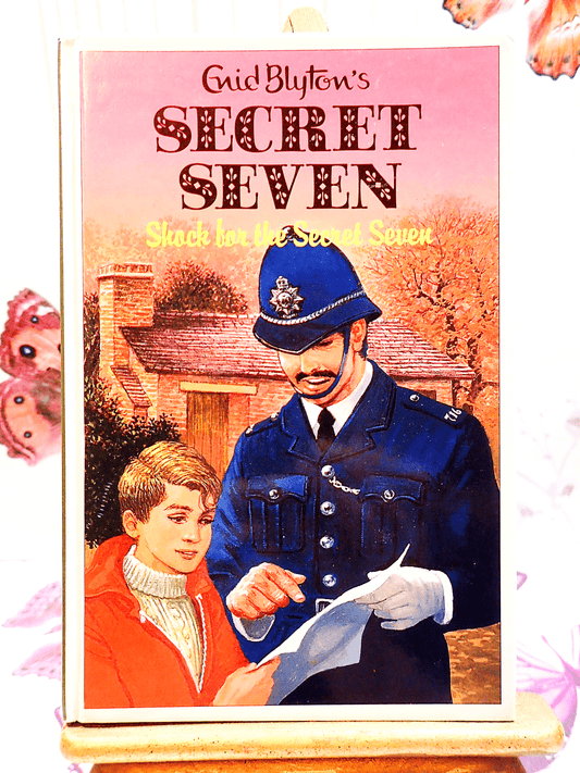 Front cover of Shock for Secret Seven Enid Blyton Vintage Childrens Book hardback 1990's Mystery Adventure showing a young boy talking to a policeman.