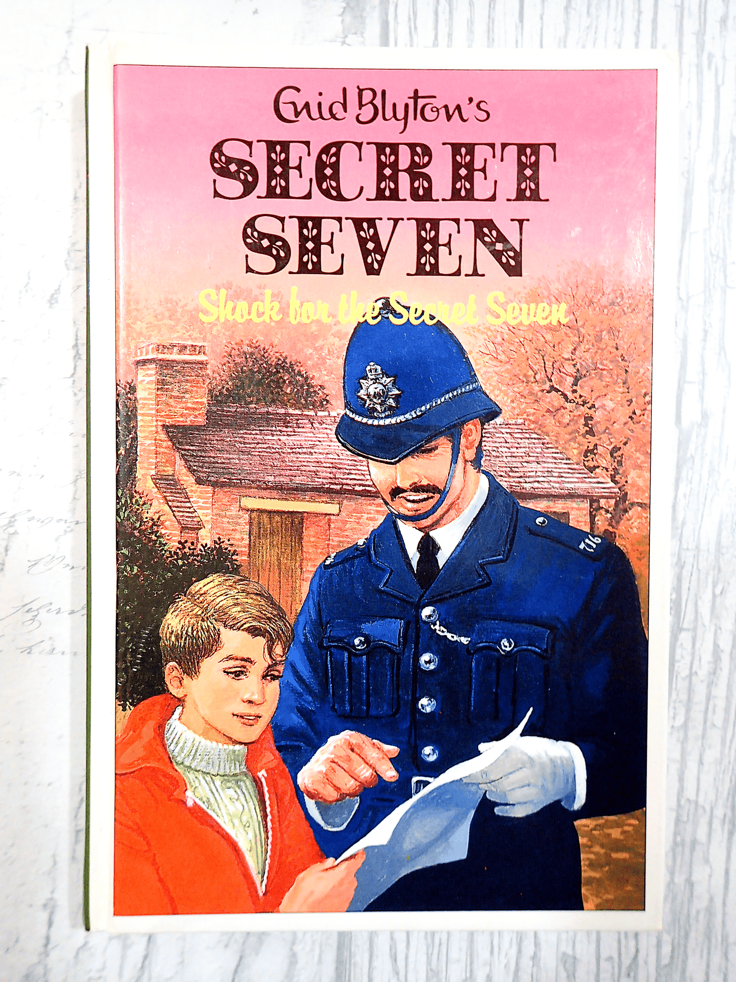 Front cover of Shock for Secret Seven Enid Blyton Vintage Childrens Book hardback 1990's Mystery Adventure showing a young boy talking to a policeman.