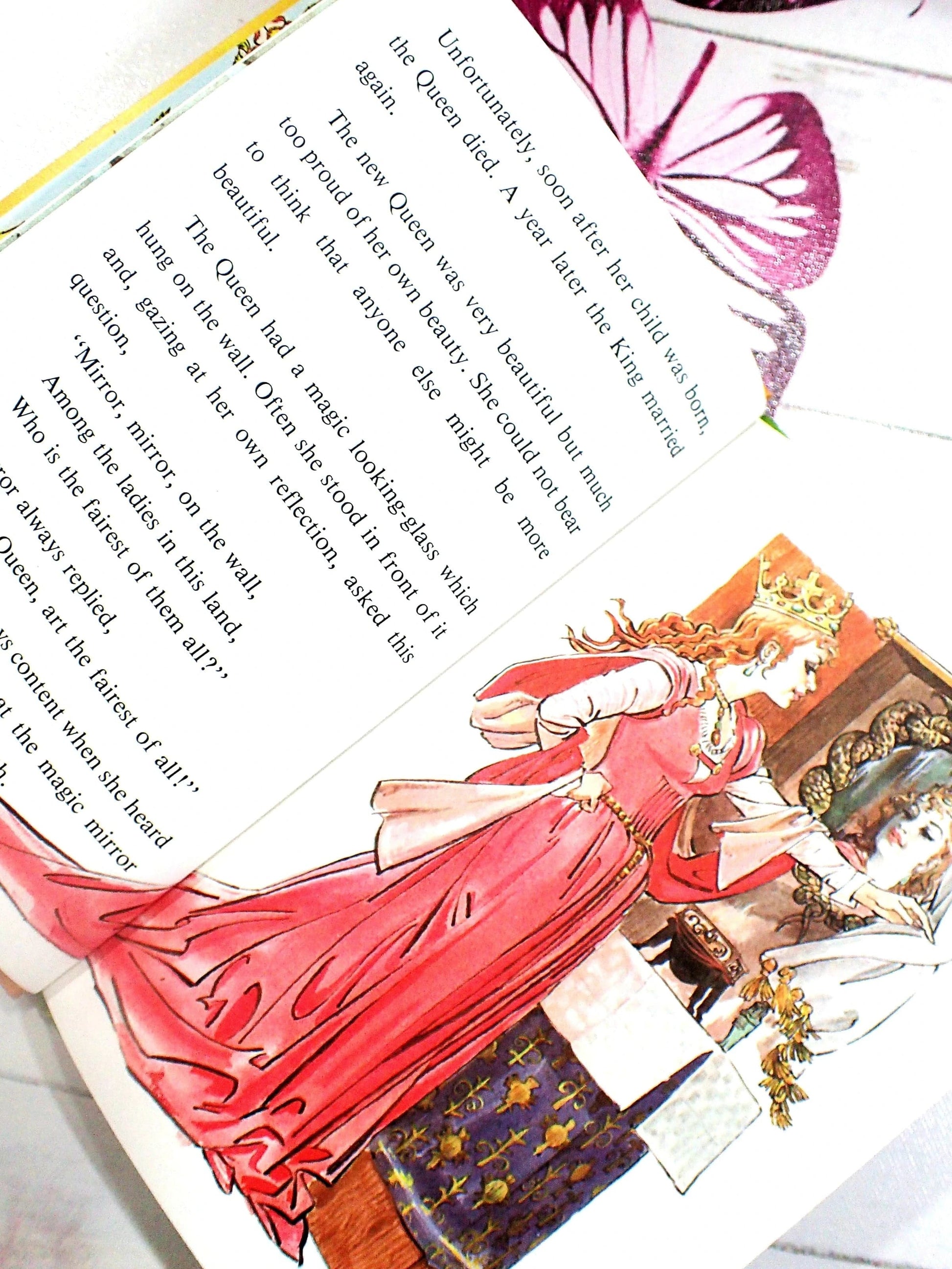 The Evil Queen looking in the magic mirror Snow White.