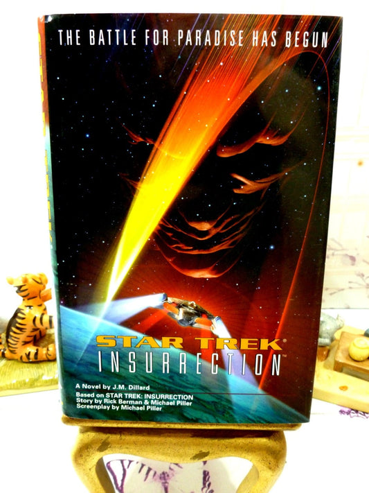 Front cover of vintage book showing monstrous face looking at the Star Ship Enterprise. Star Trek Insurrection First Edition1st Print Star Trek Novel Pocket Books 1998