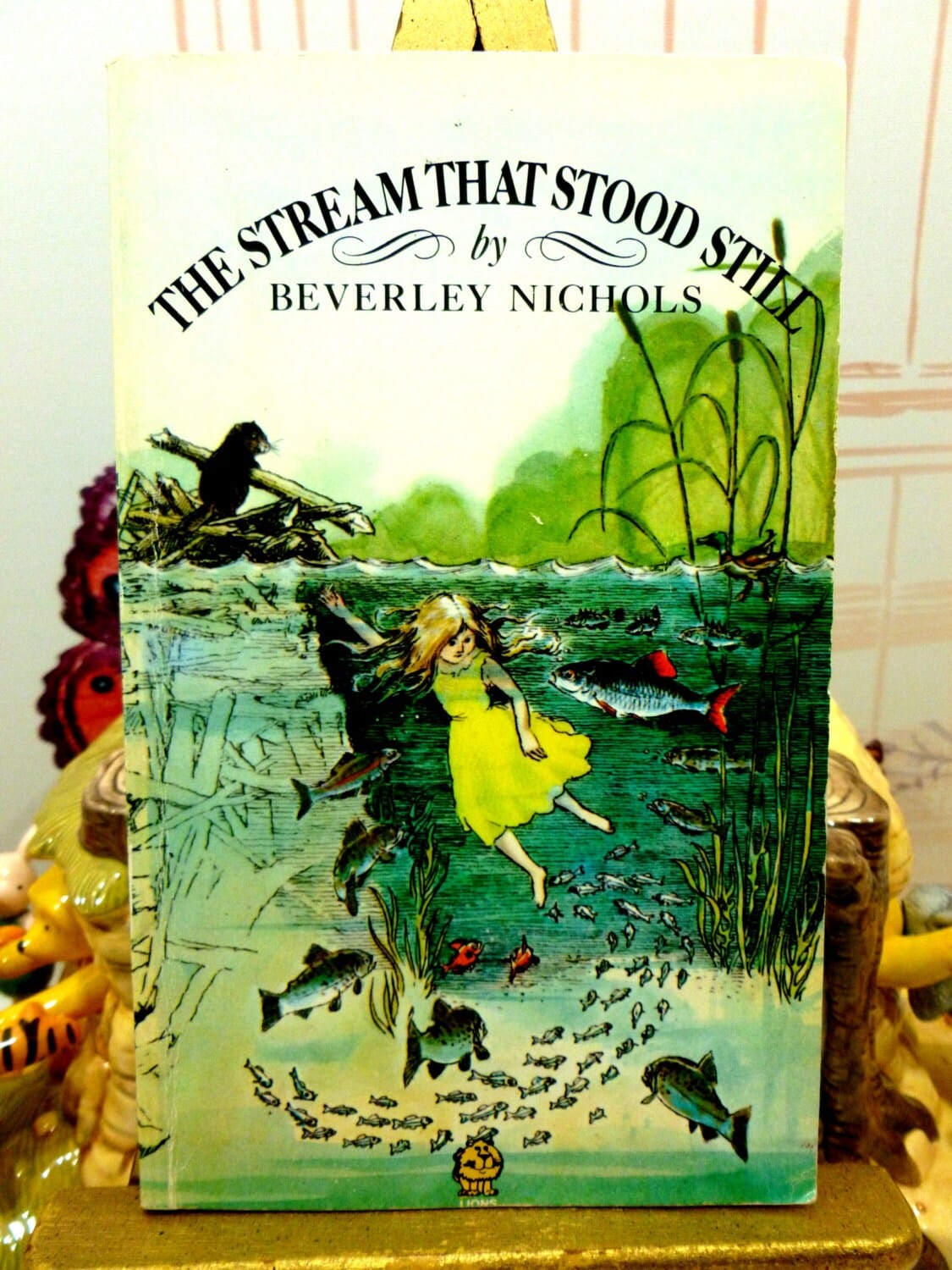 Front cover of The Stream that Stood Still Beverley Nichols Childrens Classic Vintage Fontana Lions Paperback showing a girl swimming with fishes.