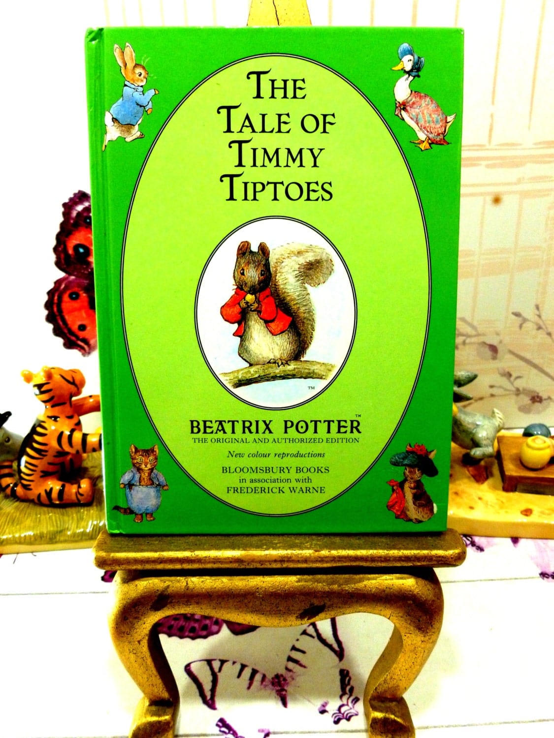 Front cover of The Tale of Timmy Tiptoes First Edition Bloomsbury Book 1993 with Timmy Tiptoes Squirrel cameo and other Beatrix Potter characters.