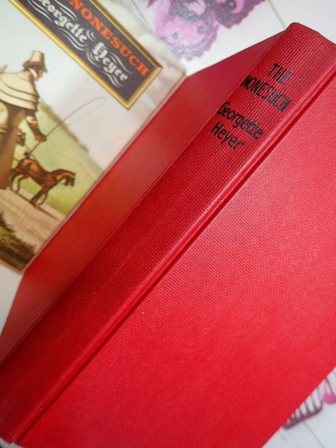 Red binding of Vintage Romance Book The Nonesuch by Georgette Heyer Historical Regency Novel.